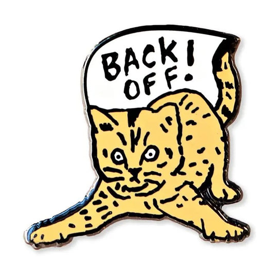 Enamel pin depicting an orange kitten in an aggressive pose with a speech bubble that reads "Back off!"