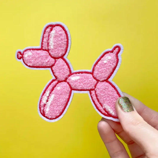 Iron on fabric patch in the shape of a pink balloon dog