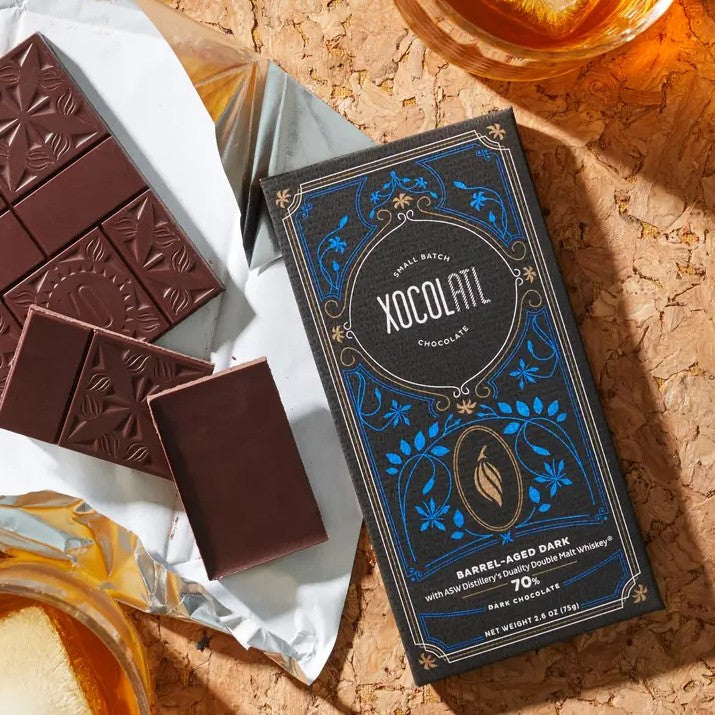 Dark chocolate bar in black wrapper with blue floral detailing