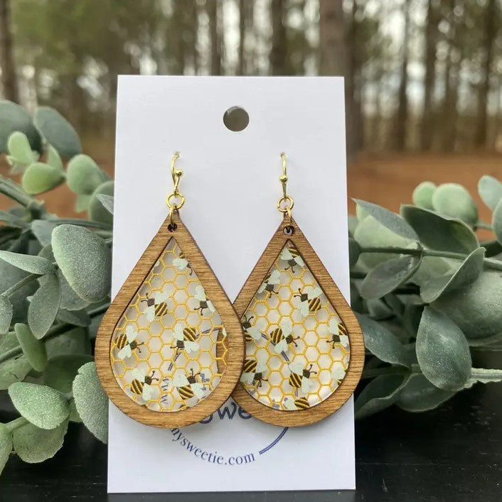 wood earrings with a resin middle filled with bees