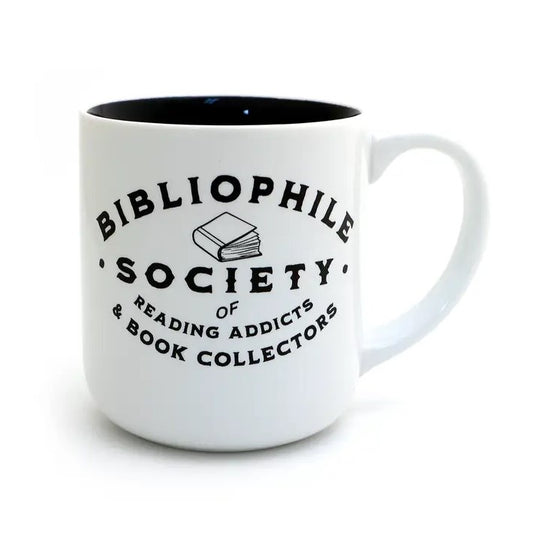 White mug that reads "Bibliophile society of reading addicts and book collectors" in black font with a small book illustration