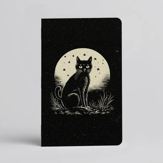 Black notebook with an illustration of a cat sitting in front of a full moon on the cover