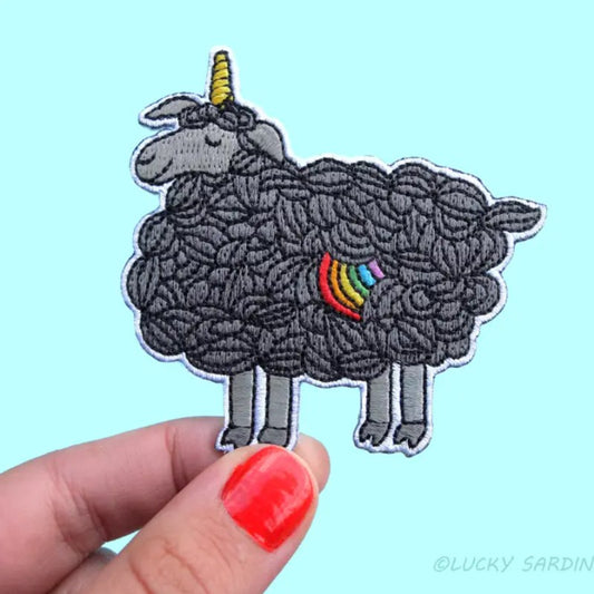 Black sheep fabric patch with a unicorn horn and a rainbow spot