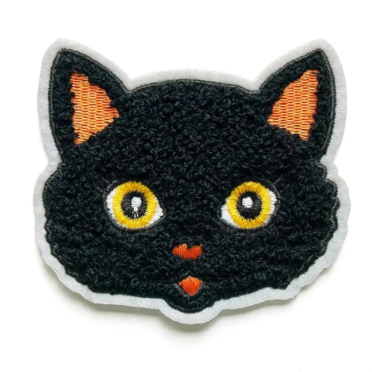 Embroidered fabric patch shaped like a black cat face