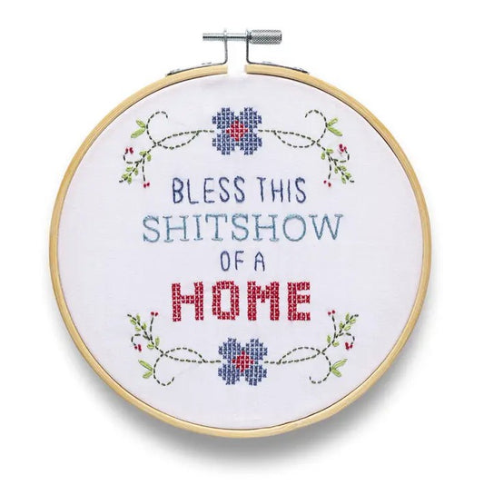 Embroidery hoop with floral accents and text "Bless this shitshow of a home"