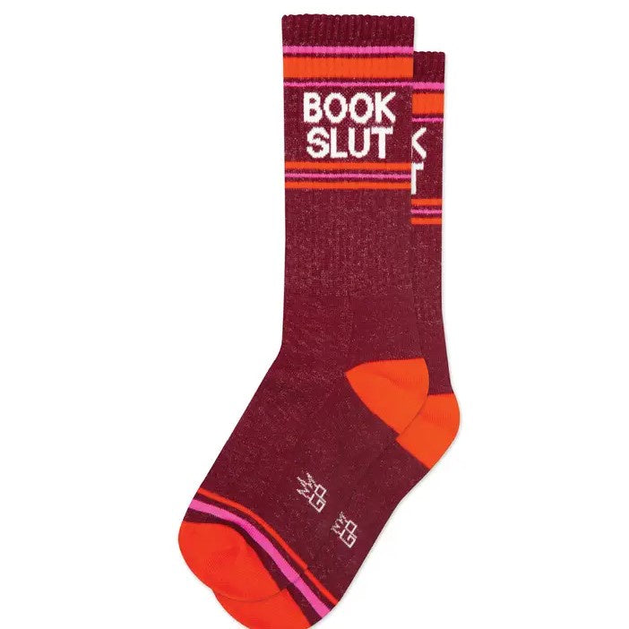 Pair of dark red, orange and pink striped calf socks with the words "Book Slut" printed at the top.