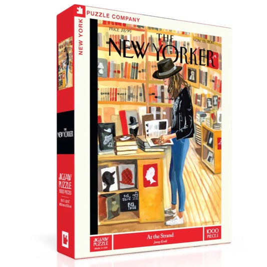 A 1000-piece puzzle depicting a woman in a black fedora hat browsing through books about hats in New York's Strand bookstore.