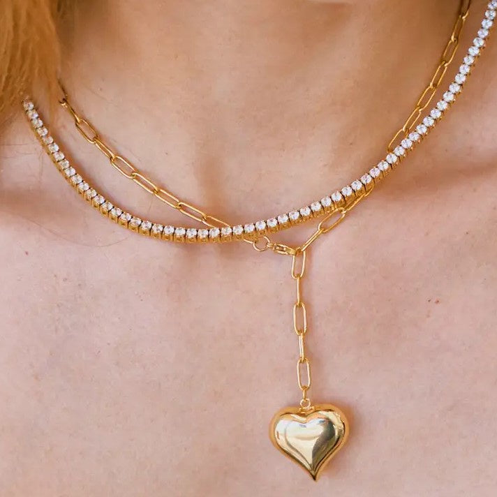 Gold chain necklace with a dangling gold heart charm