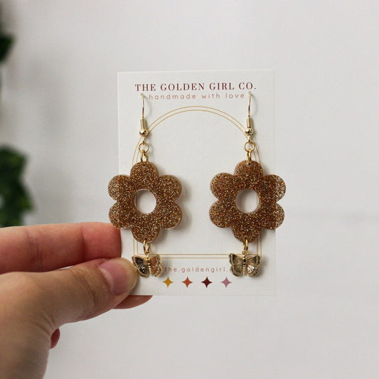 gold butterfly and resin flower earrings