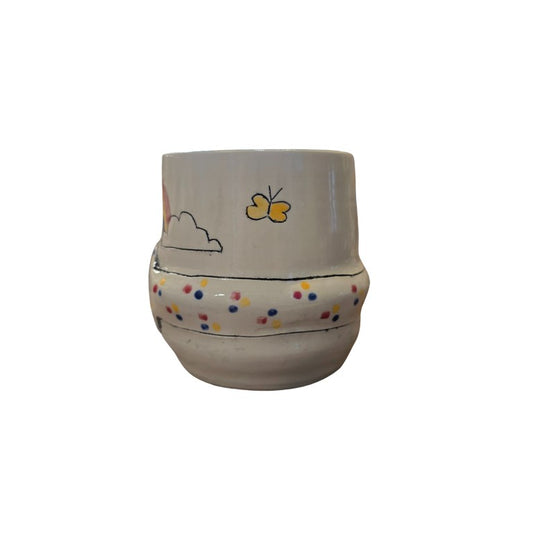 White ceramic vase with butterflies and polka dots painted on it