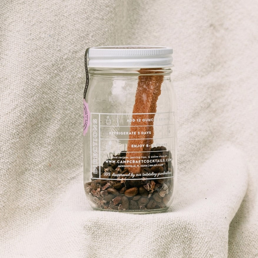 coffee beans and chunk of sugar inside a jar where you add liquid to make a cocktail