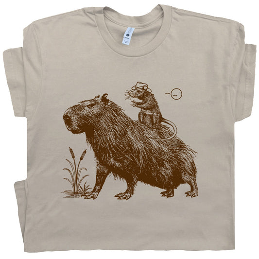 a rat wearing a cowboy hat is riding a capybara on this t-shirt design