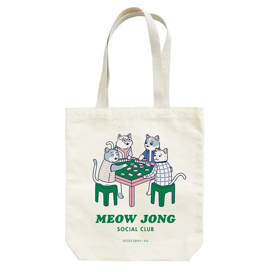 A canvas tote bag featuring a graphic of four cats wearing clothes, sitting around a table and playing mah jong. Green text reads "Meow Jong Social Club"