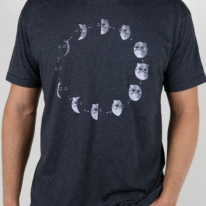 A dark gray tee shirt showing a circular cycle of moon phases, but the moon is a round kitten face with big eyes.