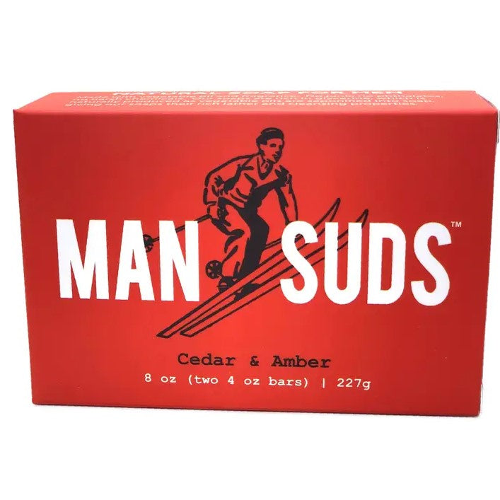 A bar of soap in the scent cedar and amber featuring an illustration of a skiing man on the front of the box.