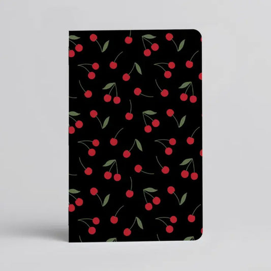 Black notebook with a cherry pattern on the cover