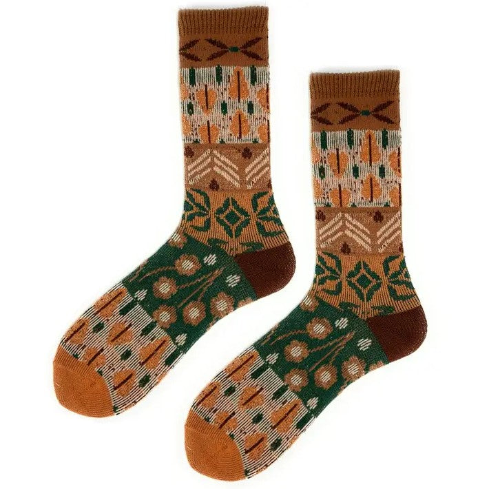 Pair of women's socks with mismatching brown, orange and white floral patterns