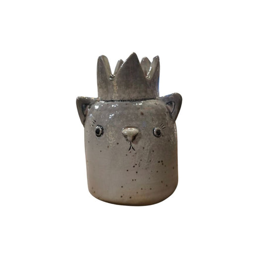 A gray ceramic sculpture of a cat face with small ears and a large crown on top