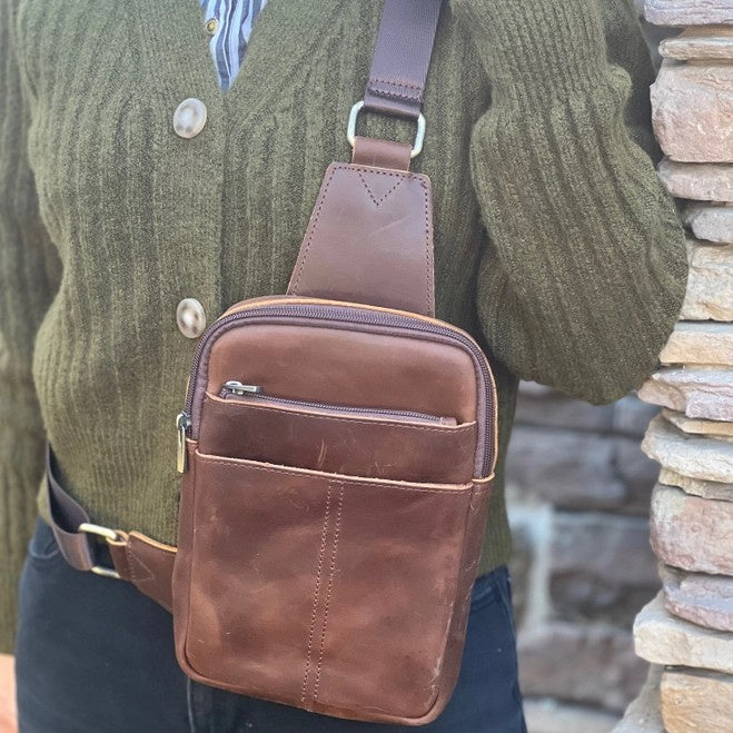 Brown leather sling bag with multiple compartments