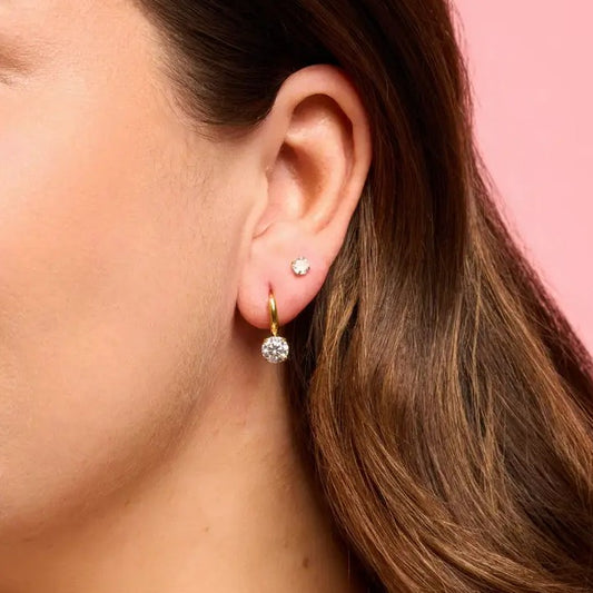 Small gold huggie earring with a crystal charm