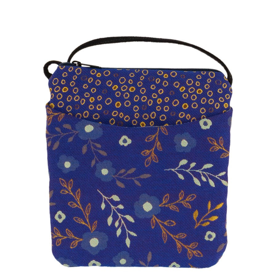 A small blue purse with mismatching yellow floral and yellow dot prints with one pocket in the front and a zipper closure at the top.