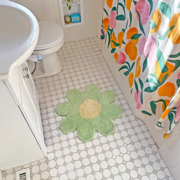 daisy rug on a tiled bathroom floor