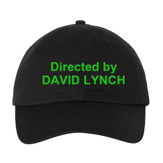 Black ball cap with bright green stitching that reads "Directed by David Lynch"