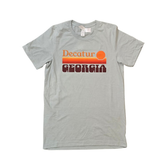 Light blue t-shirt with minimalist sunset graphic and text "Decatur Georgia"
