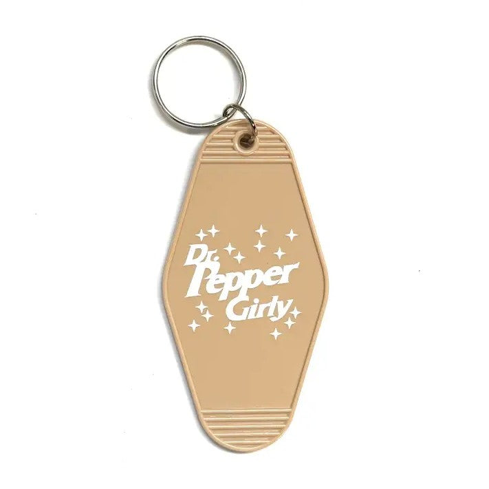 Light brown keychain that reads "Dr. Pepper Girly"