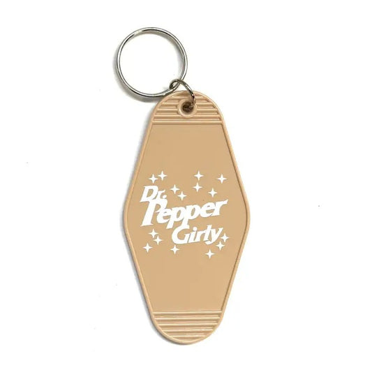 Light brown keychain that reads "Dr. Pepper Girly"