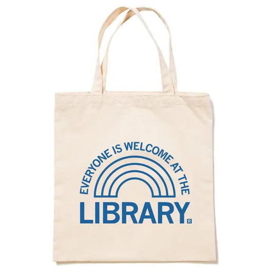 White tote bag with a simple blue rainbow graphic and text "Everyone is welcome at the library"