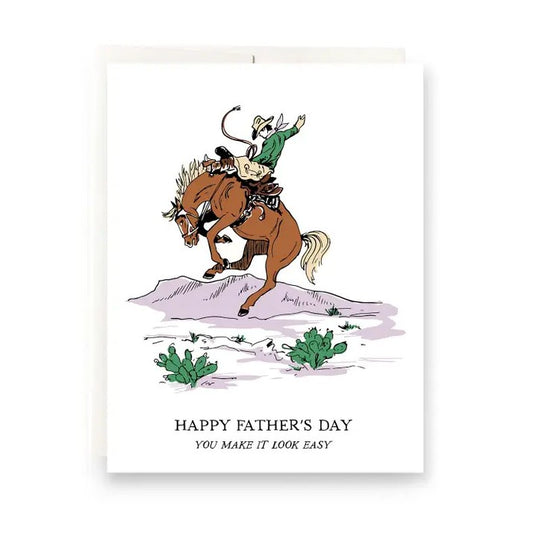 Father's Day card with an illustration of a man riding a bucking bronco and text "Happy Father's Day, you make it look easy"