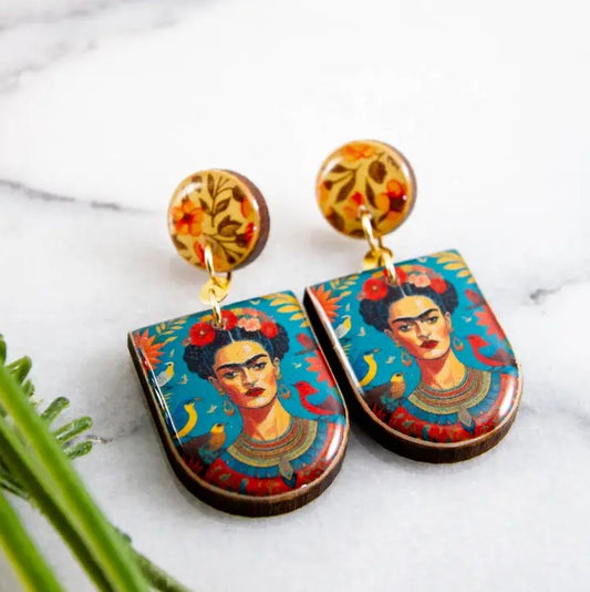 Dangle earrings with paintings of Frida Kahlo on them 