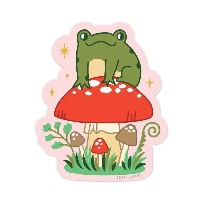 Pink sticker featuring a smiling cartoon frog sitting atop a big red toadstool.