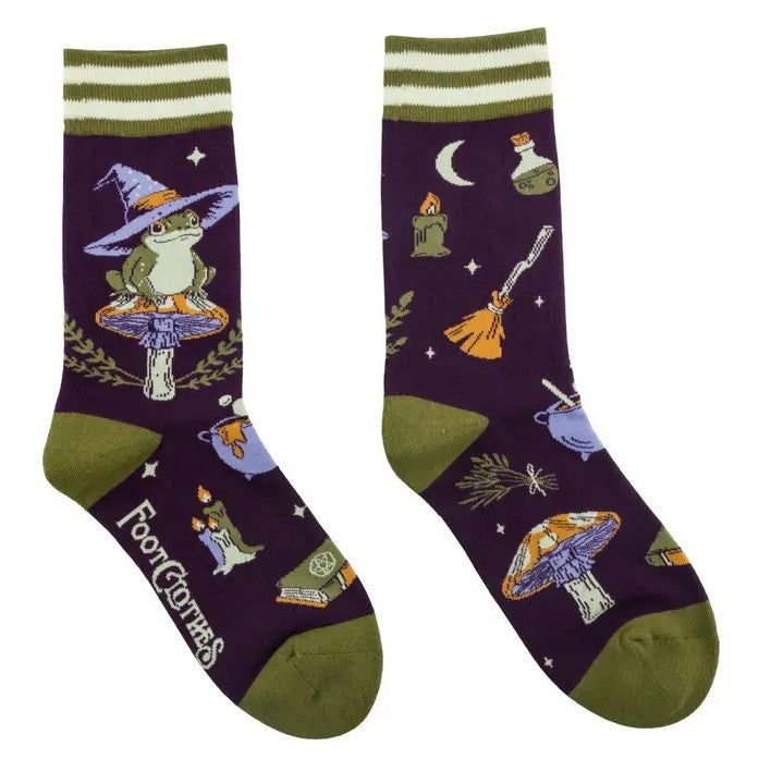 Pair of dark purple crew socks patterned with frogs in witch hats, toadstools and cauldrons 