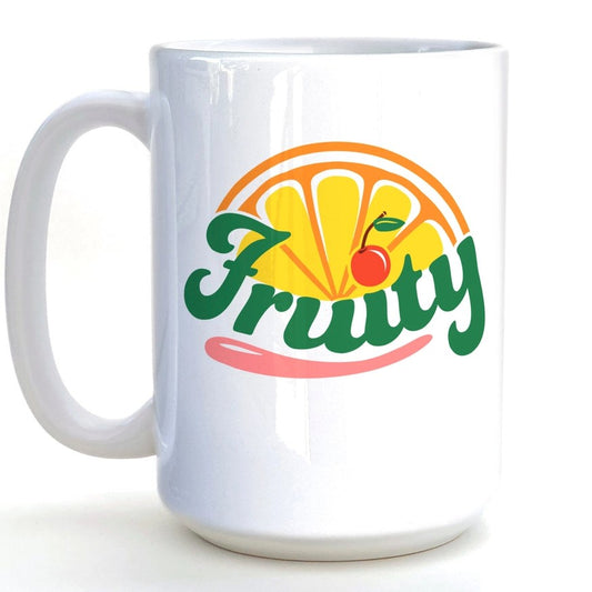 White ceramic mug with green cursive text "Fruity" and orange slice