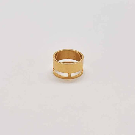 A thick gold ring with a geometric cutout band at the bottom.