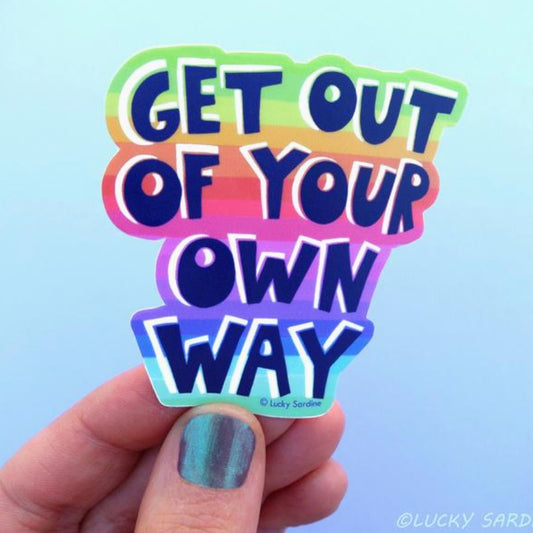 A sticker with blue text "Get out of your own way" over a striped rainbow background