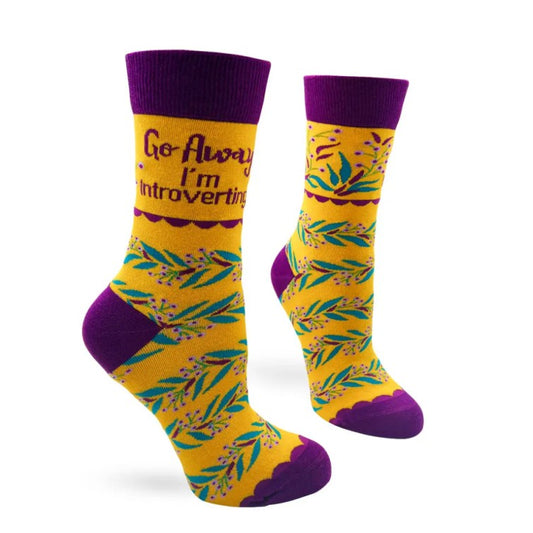 Yellow socks with purple accents and floral pattern and text "Go away I'm introverting"