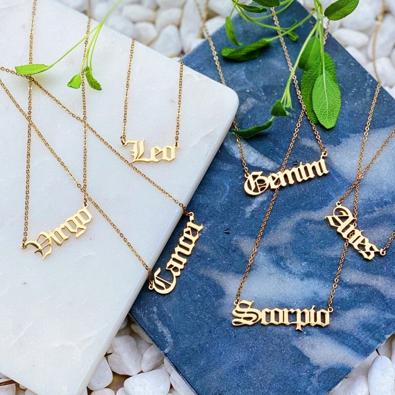 Gold necklaces with the names of Zodiac signs 