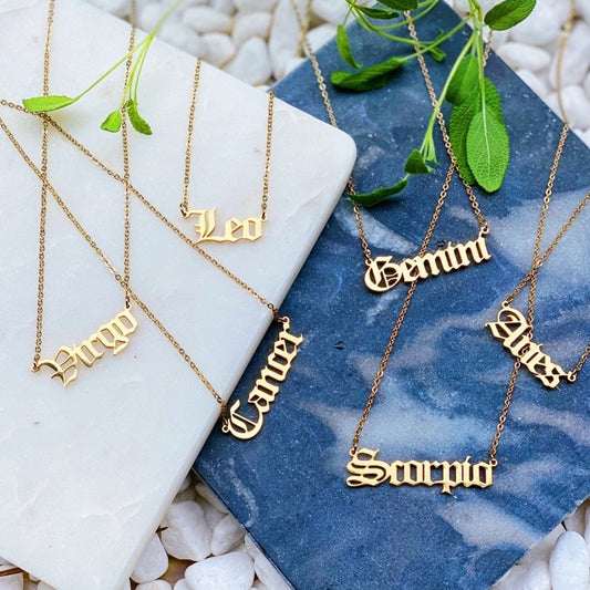 Gold necklaces with the names of Zodiac signs 
