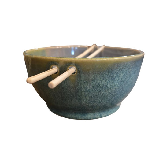 Green ceramic bowl designed to hold chopsticks
