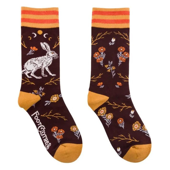 Maroon socks with a pattern featuring yellow flowers and white hares