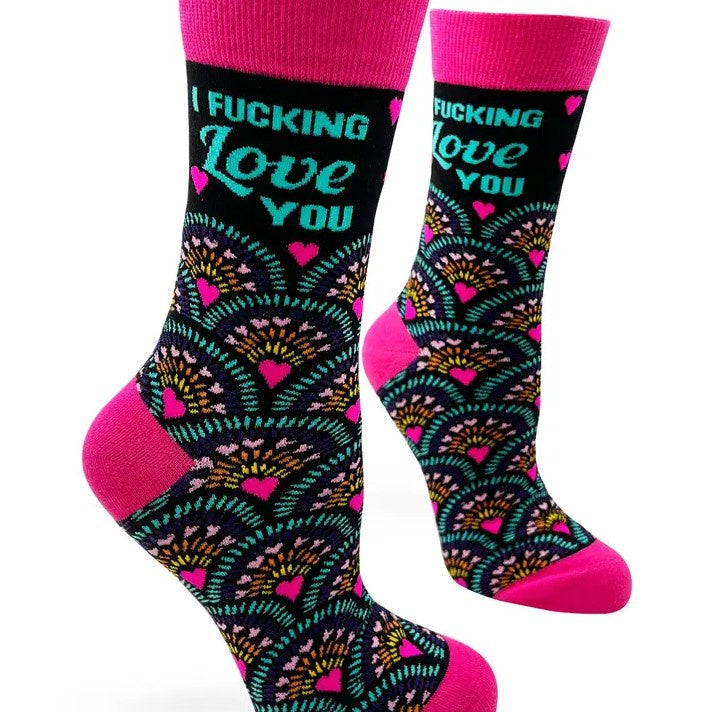 A pair of calf socks with a hot pink exploding heart pattern over a black background and the words "I fucking love you."