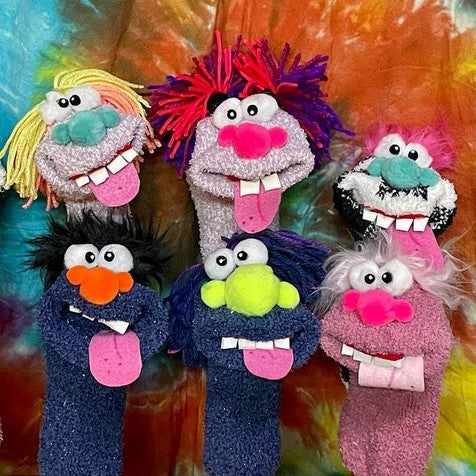 Six Handmade Sock Puppets with their tongues and teeth sticking out