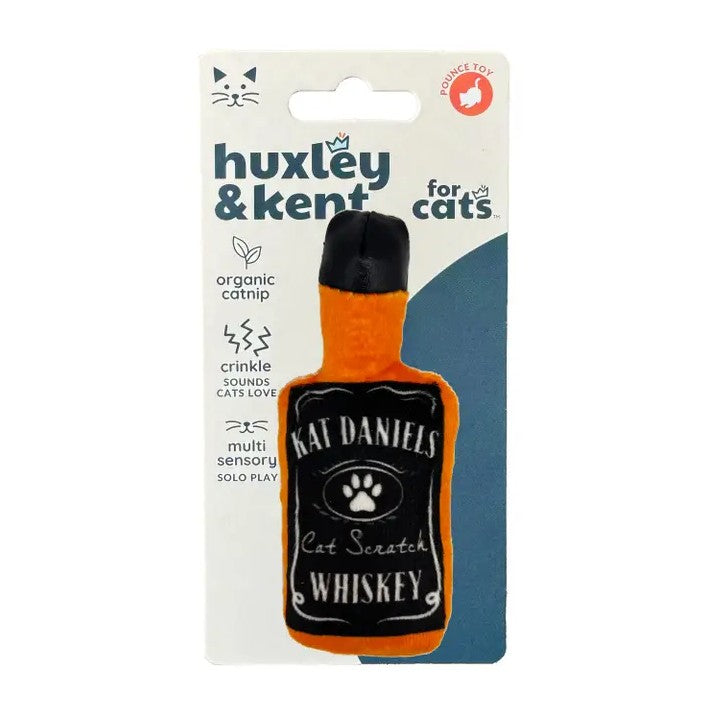 A Huxley & Kent 'Cat Scratch Whiskey' catnip toy shaped like a miniature whiskey bottle, packaged on its original white and blue cardboard backing card.