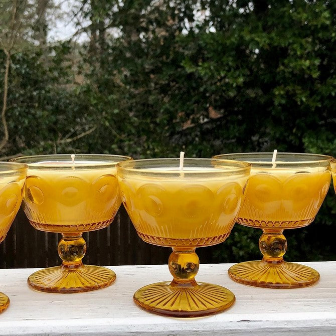 Candles inside vintage yellow glass jars