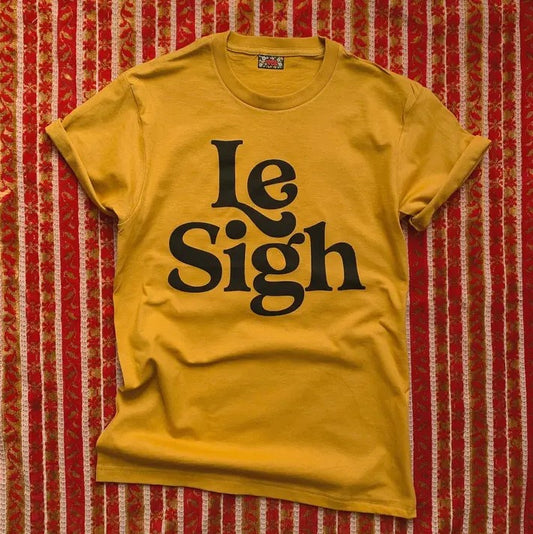 le sigh black text on yellow shirt