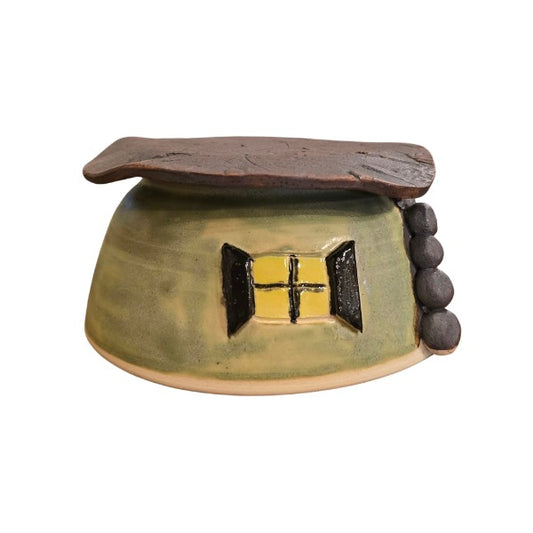 Small ceramic toad house with a window design on the side