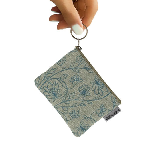 Coin purse with a delicate beige and teal floral pattern